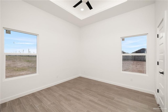 spare room with a ceiling fan, recessed lighting, baseboards, and wood finished floors