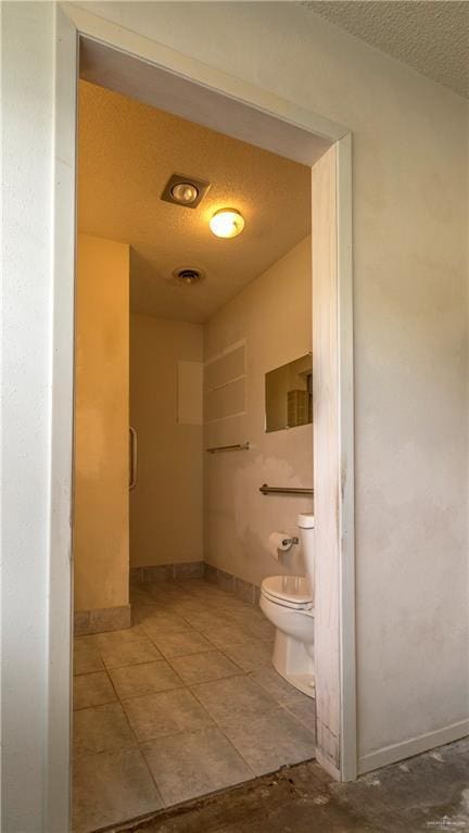 300 W Westway Ave, Mcallen, TX 78501 - bathroom with toilet, a textured ceiling, and baseboards