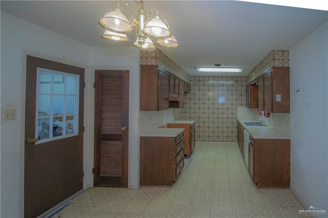 300 W Westway Ave, Mcallen, TX 78501 - kitchen featuring a sink, a chandelier, light countertops, brown cabinets, and baseboards