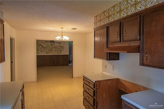300 W Westway Ave, Mcallen, TX 78501 - kitchen with a chandelier, a textured ceiling, light flooring, under cabinet range hood, and pendant lighting