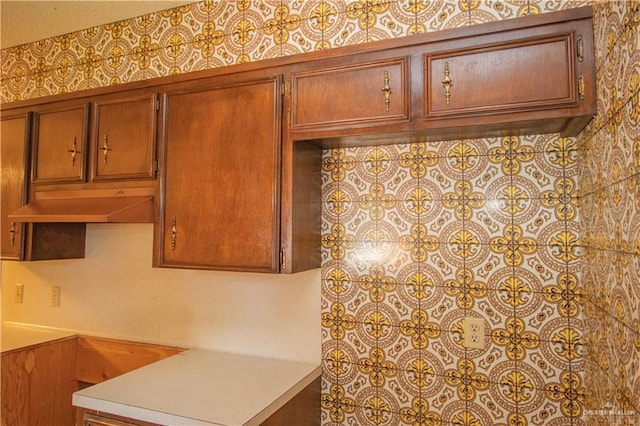 300 W Westway Ave, Mcallen, TX 78501 - kitchen with under cabinet range hood, light countertops, and brown cabinets