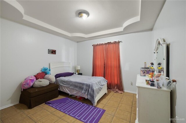 bedroom featuring a raised ceiling