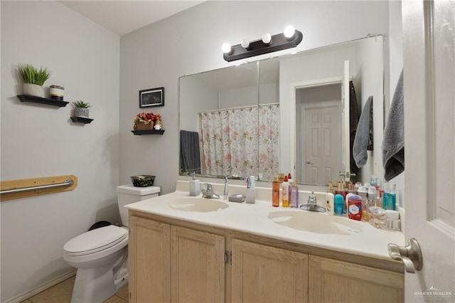 bathroom featuring toilet, vanity, and tile patterned floors