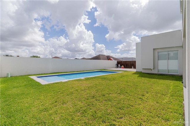 view of pool featuring a lawn