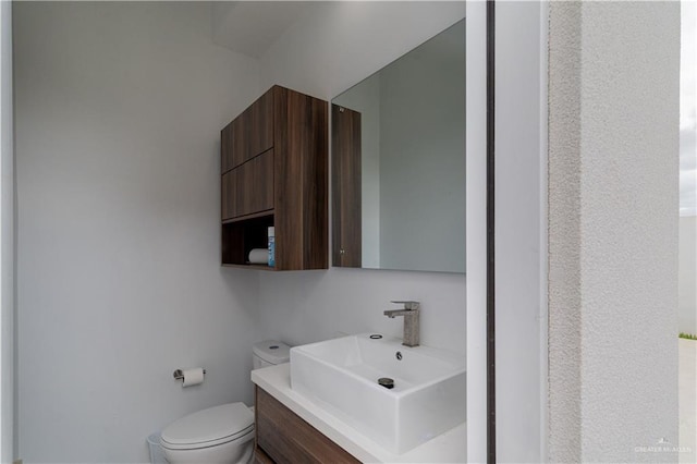 bathroom featuring vanity and toilet