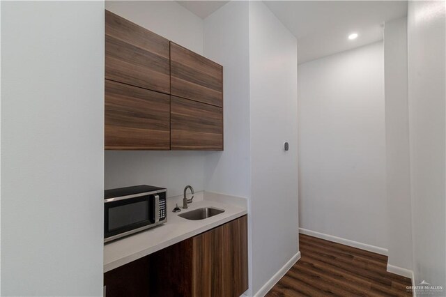 kitchen with dark hardwood / wood-style flooring and sink