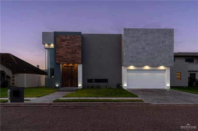 contemporary house with a yard and a garage