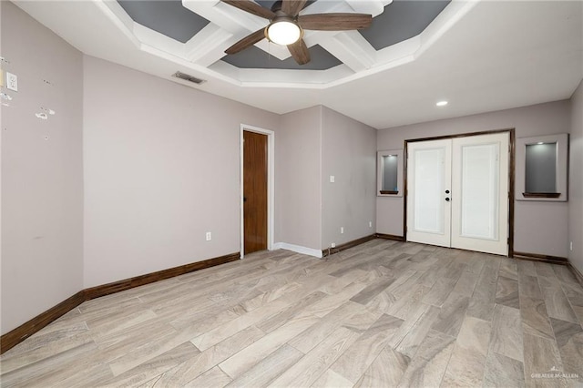 unfurnished bedroom featuring coffered ceiling, a closet, french doors, beam ceiling, and ceiling fan