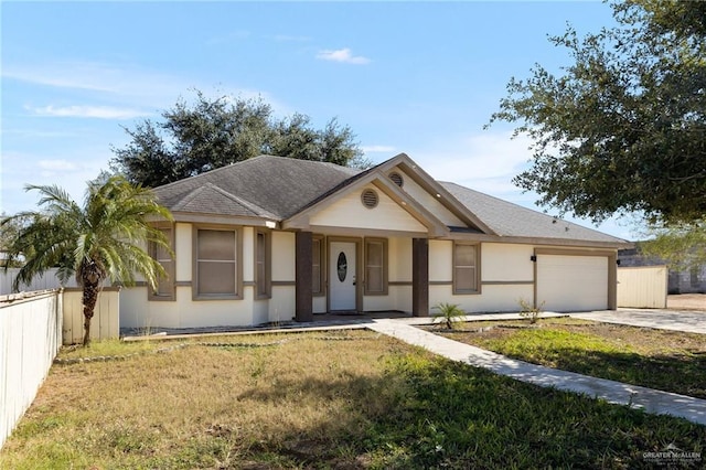 view of front of house with a garage and a front yard