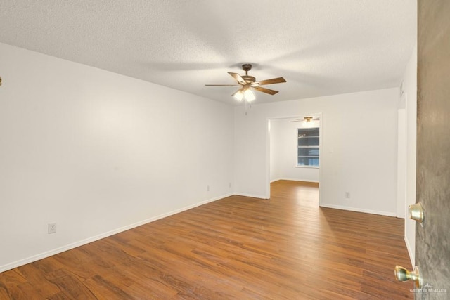 unfurnished room featuring hardwood / wood-style flooring, a textured ceiling, and ceiling fan