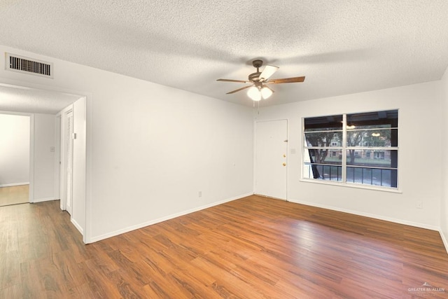 spare room featuring hardwood / wood-style floors, a textured ceiling, and ceiling fan