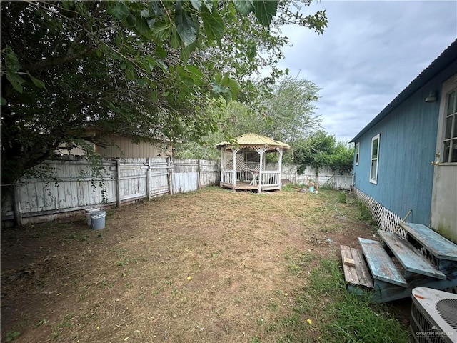 view of yard with a gazebo, a deck, and central air condition unit