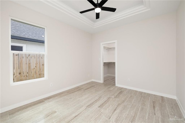 404 Imperial Dr, San Juan, TX 78589 - empty room featuring wood finished floors, ornamental molding, ceiling fan, a raised ceiling, and baseboards