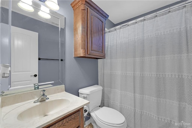 bathroom with vanity, walk in shower, and toilet