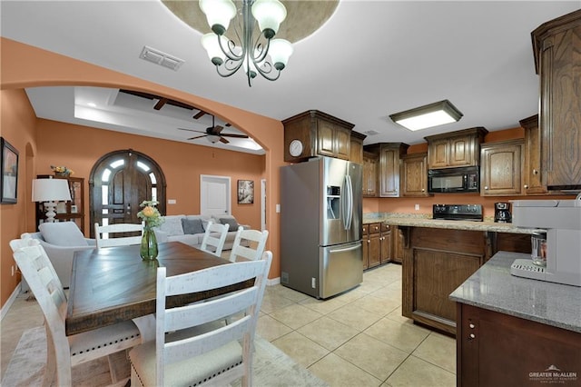 kitchen with electric stove, light tile patterned floors, hanging light fixtures, stainless steel refrigerator with ice dispenser, and light stone countertops