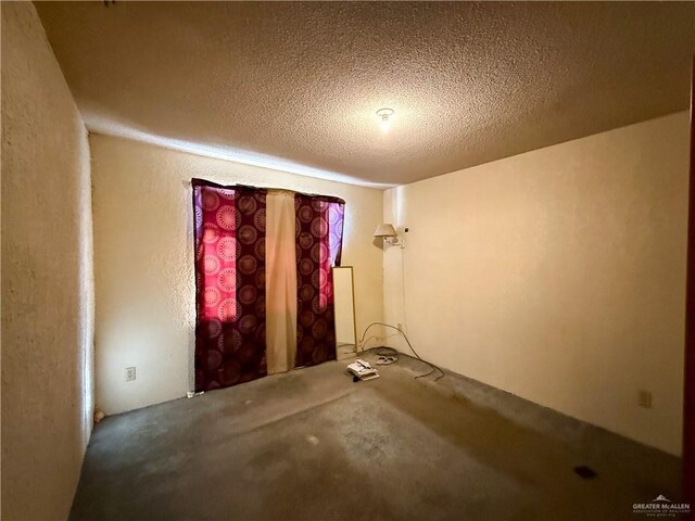 empty room with a textured ceiling