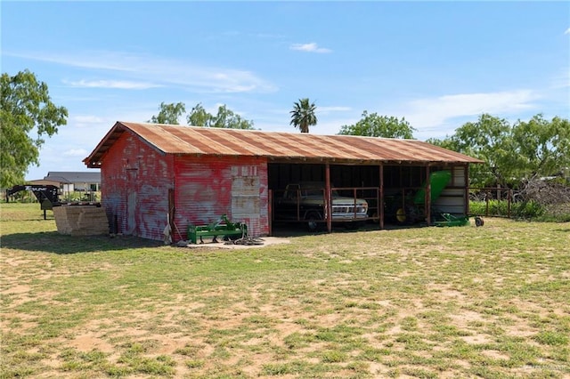 view of pole building with a yard
