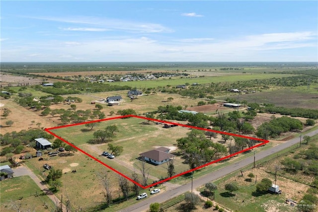 birds eye view of property with a rural view