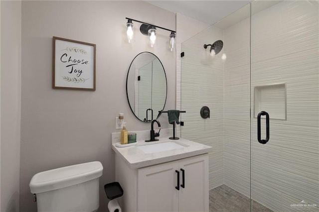 full bath featuring toilet, vanity, and a stall shower