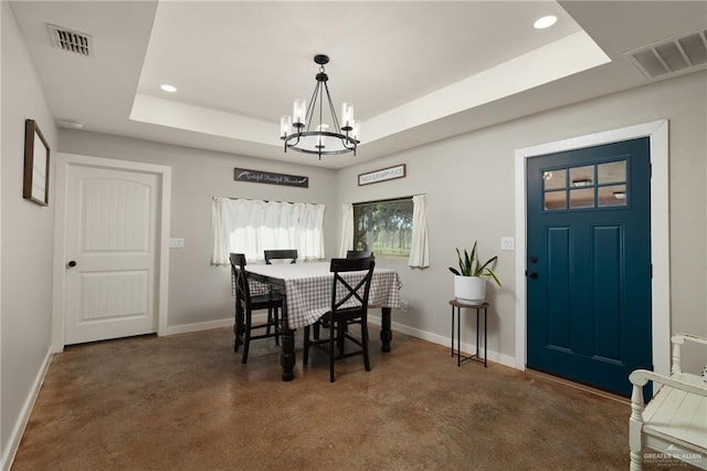 dining area featuring a raised ceiling, an inviting chandelier, and visible vents