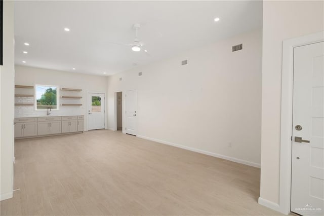 1204 N Lincoln Ave, San Juan, TX 78589 - unfurnished living room featuring ceiling fan, a sink, recessed lighting, baseboards, and light wood finished floors