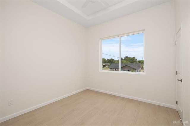 1204 N Lincoln Ave, San Juan, TX 78589 - spare room with light wood finished floors, baseboards, a ceiling fan, and a raised ceiling