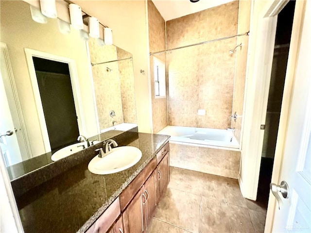 bathroom featuring vanity, tile patterned flooring, and tiled shower / bath combo