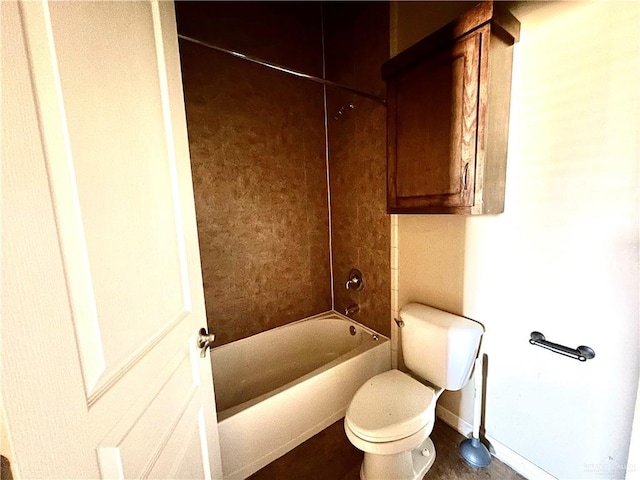 bathroom with toilet and bathtub / shower combination