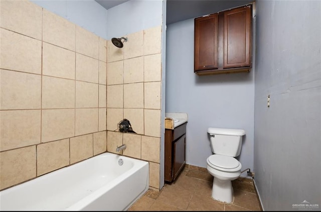 bathroom featuring tile patterned flooring, tiled shower / bath combo, and toilet