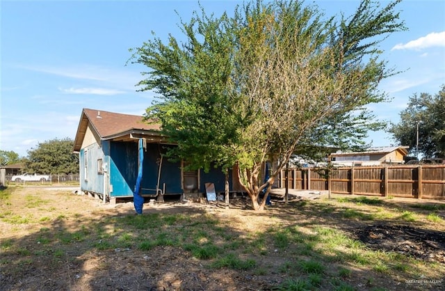 back of property featuring a storage unit