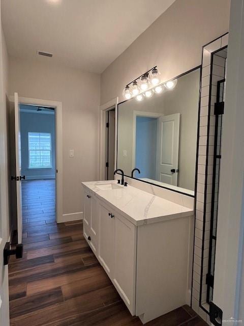 bathroom featuring hardwood / wood-style flooring and vanity