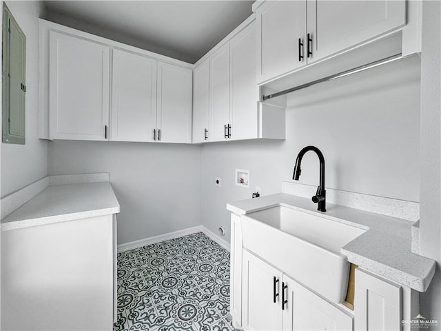 laundry room featuring electric dryer hookup, cabinets, electric panel, sink, and washer hookup