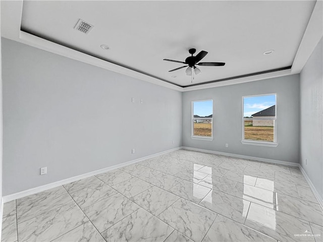 empty room with ceiling fan, crown molding, and a tray ceiling