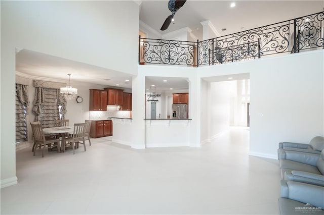 2405 San Alejandro St, Mission, TX 78572 - living area with a chandelier, a ceiling fan, a towering ceiling, and crown molding