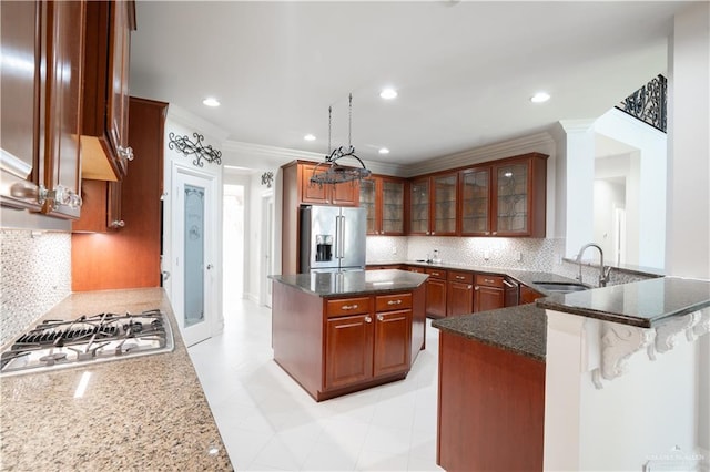2405 San Alejandro St, Mission, TX 78572 - kitchen featuring stainless steel appliances, a sink, crown molding, dark stone counters, and backsplash