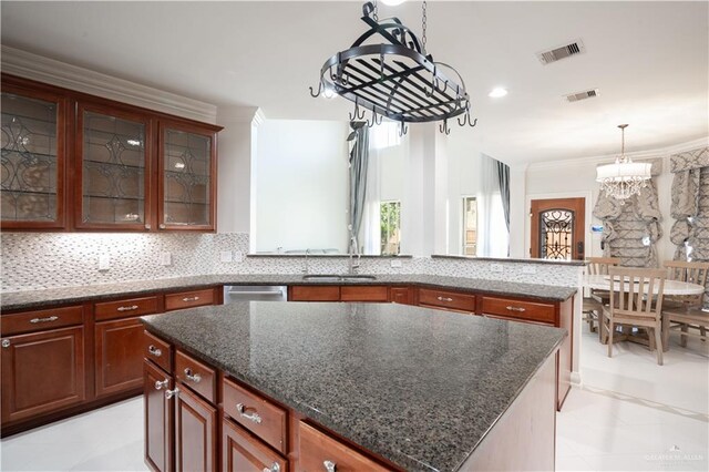 2405 San Alejandro St, Mission, TX 78572 - kitchen with a sink, a chandelier, decorative light fixtures, stainless steel dishwasher, and tasteful backsplash