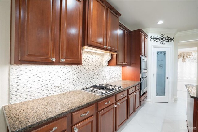 2405 San Alejandro St, Mission, TX 78572 - kitchen with stainless steel appliances, stone countertops, tasteful backsplash, crown molding, and light tile patterned floors