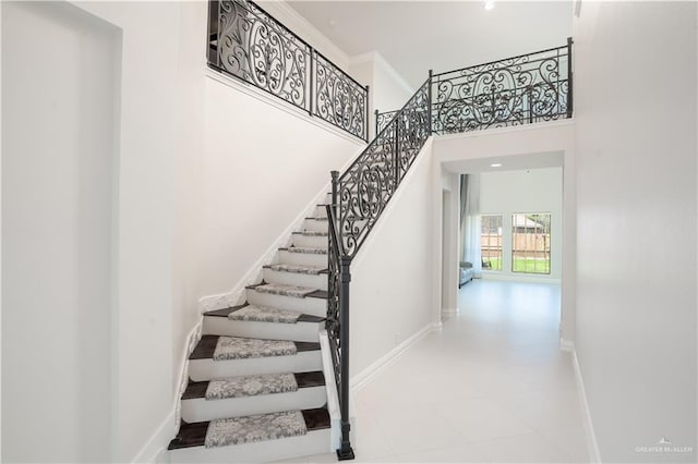 2405 San Alejandro St, Mission, TX 78572 - staircase featuring a high ceiling and baseboards