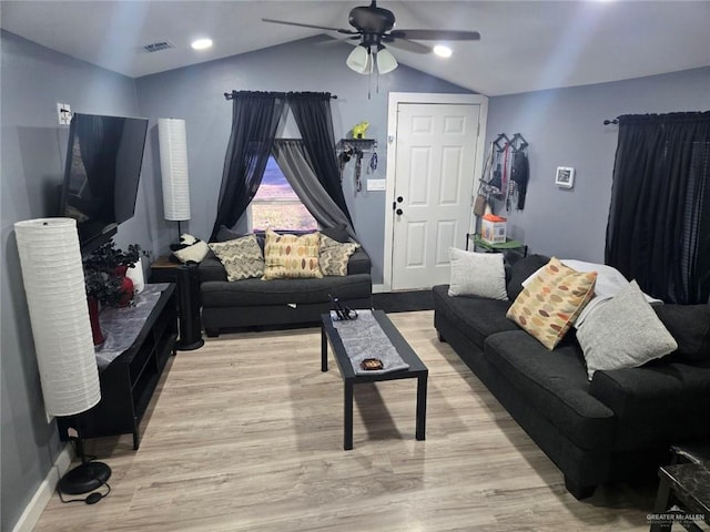 living room with light wood-type flooring, ceiling fan, and vaulted ceiling