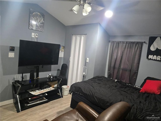 bedroom with vaulted ceiling, ceiling fan, and wood-type flooring