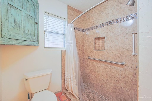 full bath with a stall shower and toilet
