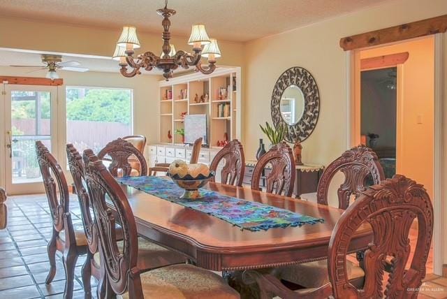 tiled dining area with ceiling fan with notable chandelier