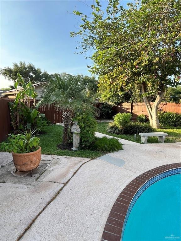 view of property's community featuring a fenced backyard and a patio area