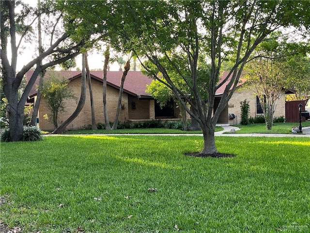 view of front of property with brick siding and a front yard