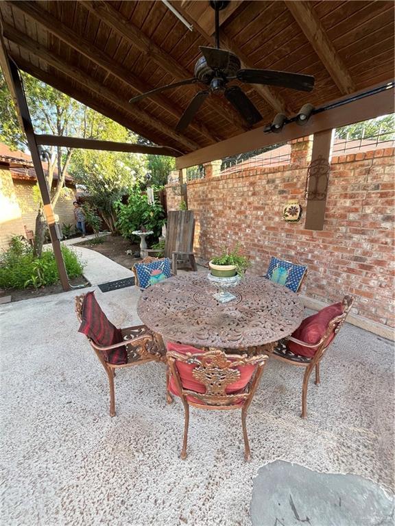 view of patio with a fenced backyard, a ceiling fan, and outdoor dining space