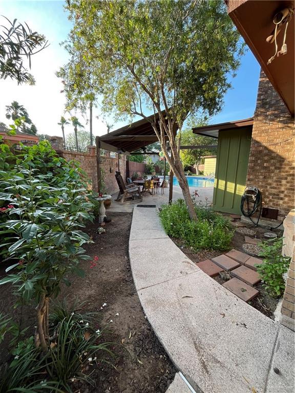 view of yard featuring a fenced in pool, a fenced backyard, and a patio area