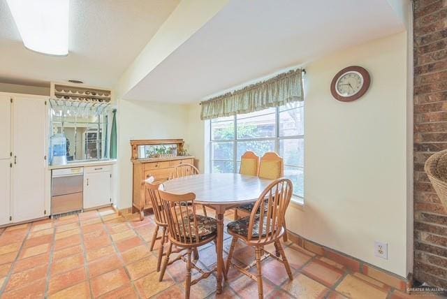 dining room featuring baseboards and light tile patterned floors
