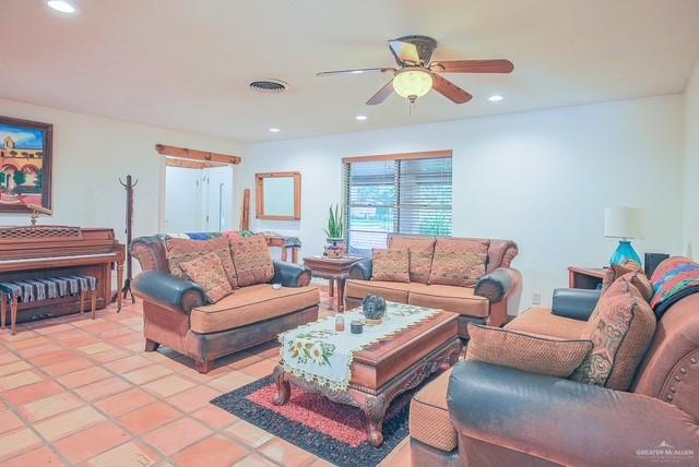 living area with light tile patterned floors, ceiling fan, recessed lighting, and visible vents
