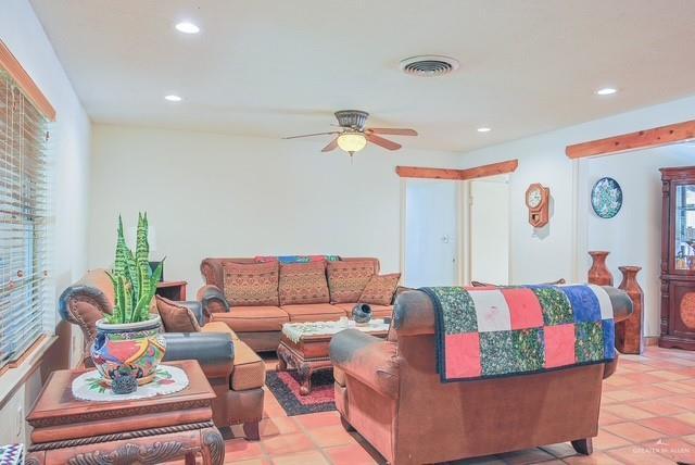 living room with visible vents, recessed lighting, ceiling fan, and light tile patterned floors