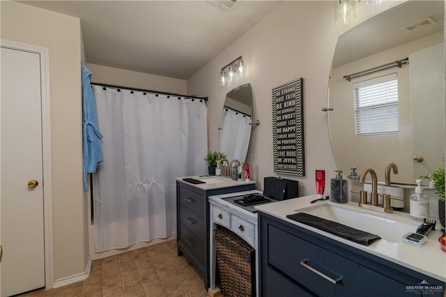 full bathroom with shower / tub combo with curtain, two vanities, visible vents, and a sink